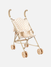 Miniature doll stroller with a polka dot seat on a white background