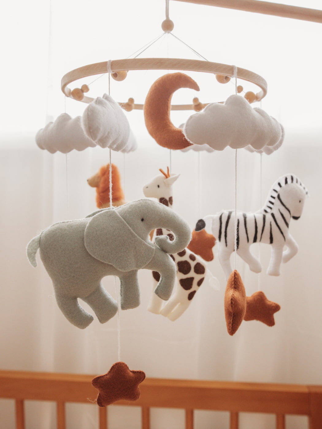 baby mobile with safari animals including an elephant, giraffe, zebra and lion
